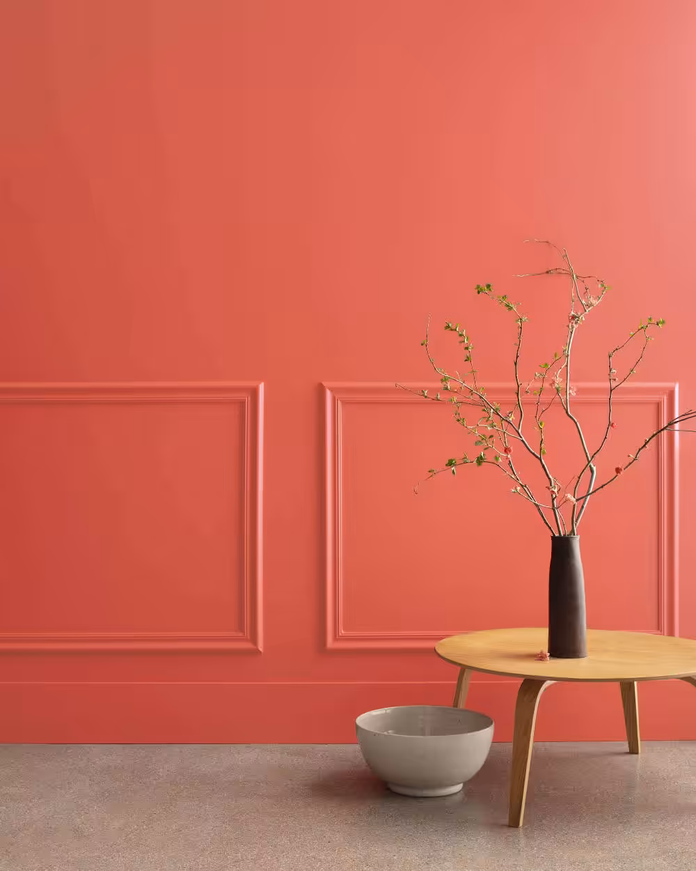 room painted in raspberry blush with carpet on the floor and table in corner