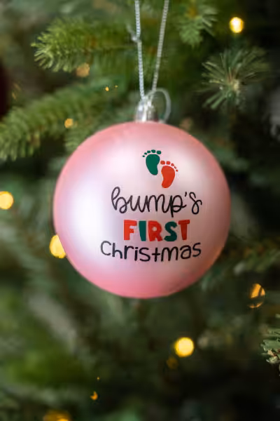 pink custom christmas tree ball with words bump's first christmas
