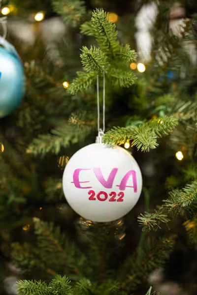 white custom christmas ornament with words Eva 2022 on it