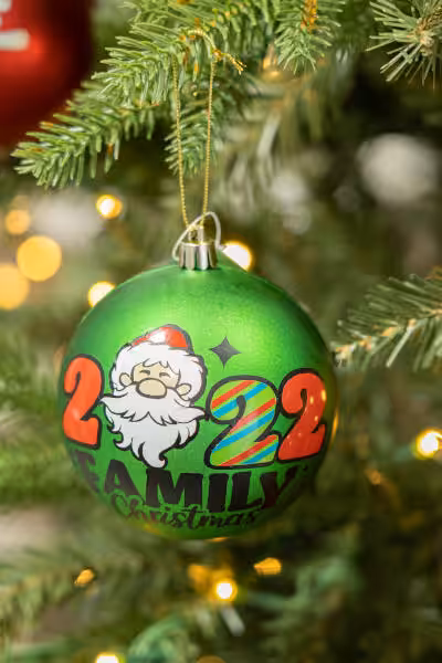 green custom christmas ornament with caricature of santa and words 2022 family