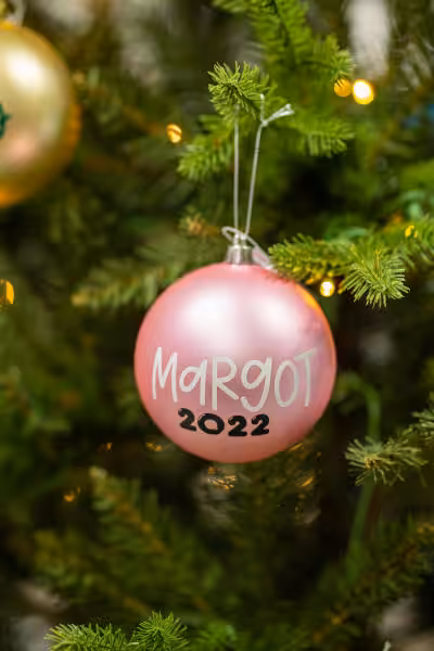 pink custom christmas ball with words margo 2022 on it