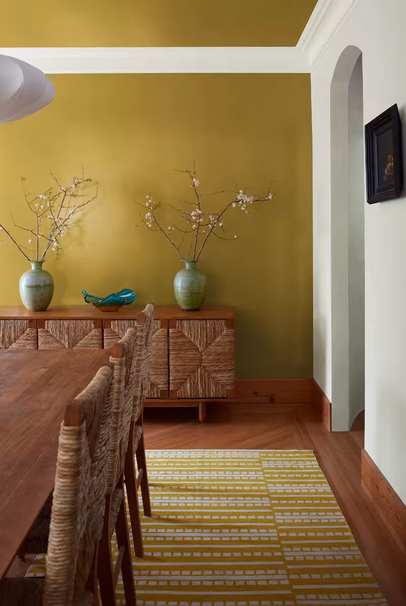room with furniture and savannagh green coloured walls and white trim