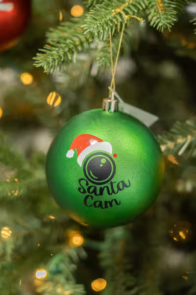green coloured custom christmas bulb with caricature of santa hat and web cam and words, santa cam