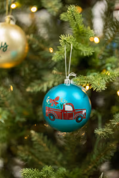 blue coloured custom christmas ornament with caricature of a pick up truck