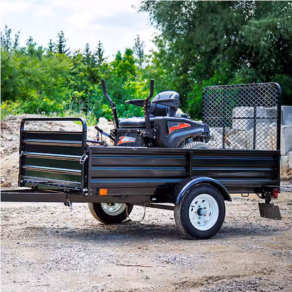 view of side of dk2 mmt5x7-dug landscaping trailer hauling zero turn mower